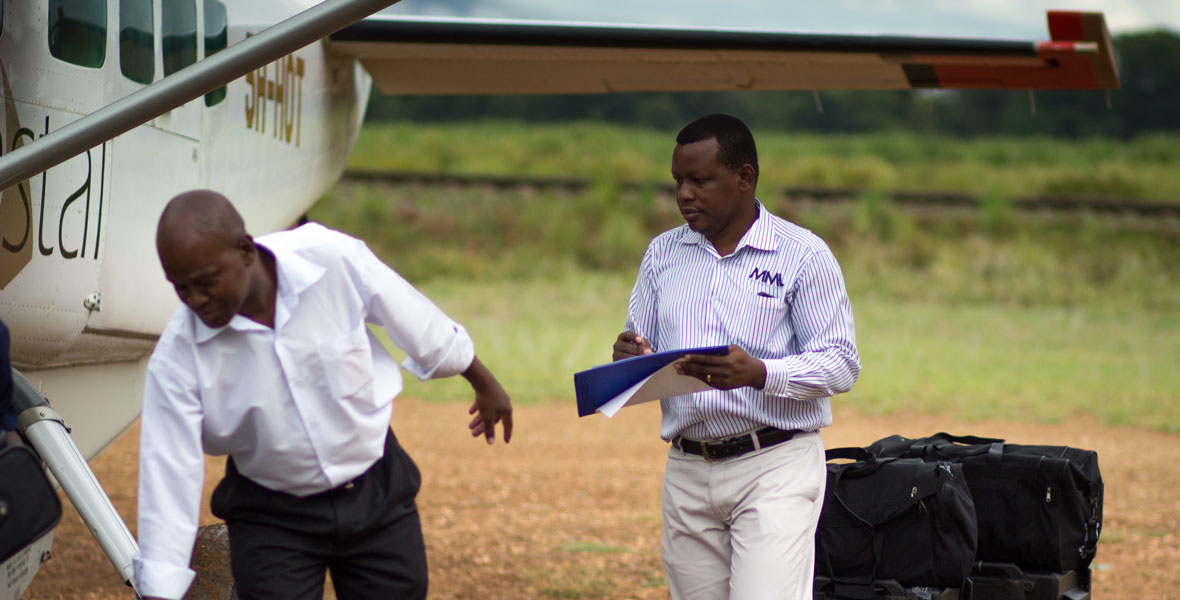 Remote site catering, camp food and food and beverage staff member checking the inventory of supplies that have just arrived by aircraft.