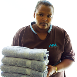 Picture of a maid holding freshly laundered towels.