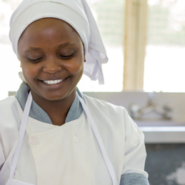 Picture of female chef cooking.